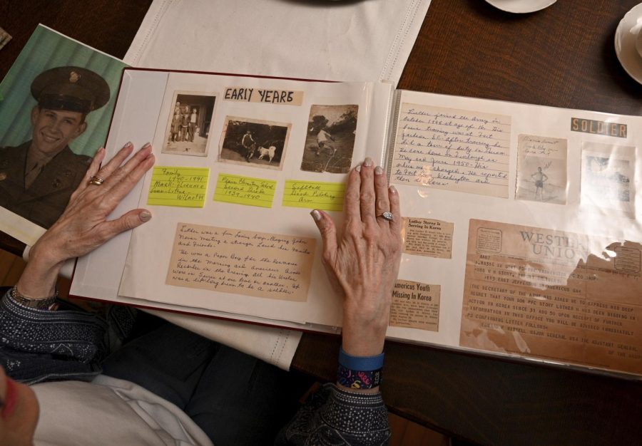 Judy Wade displays a scrapbook showcasing memories of her uncle Luther Story.