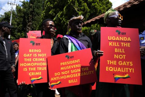 Activists hold placards during their picket against Uganda's anti-homosexuality bill at the Ugandan High Commission in Pretoria, South Africa.